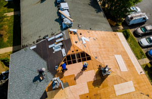 Removal of Old commercial Roof and Replacement Roofs with New Roof Shingle Being Applied Home Roof Construction All New Materials.